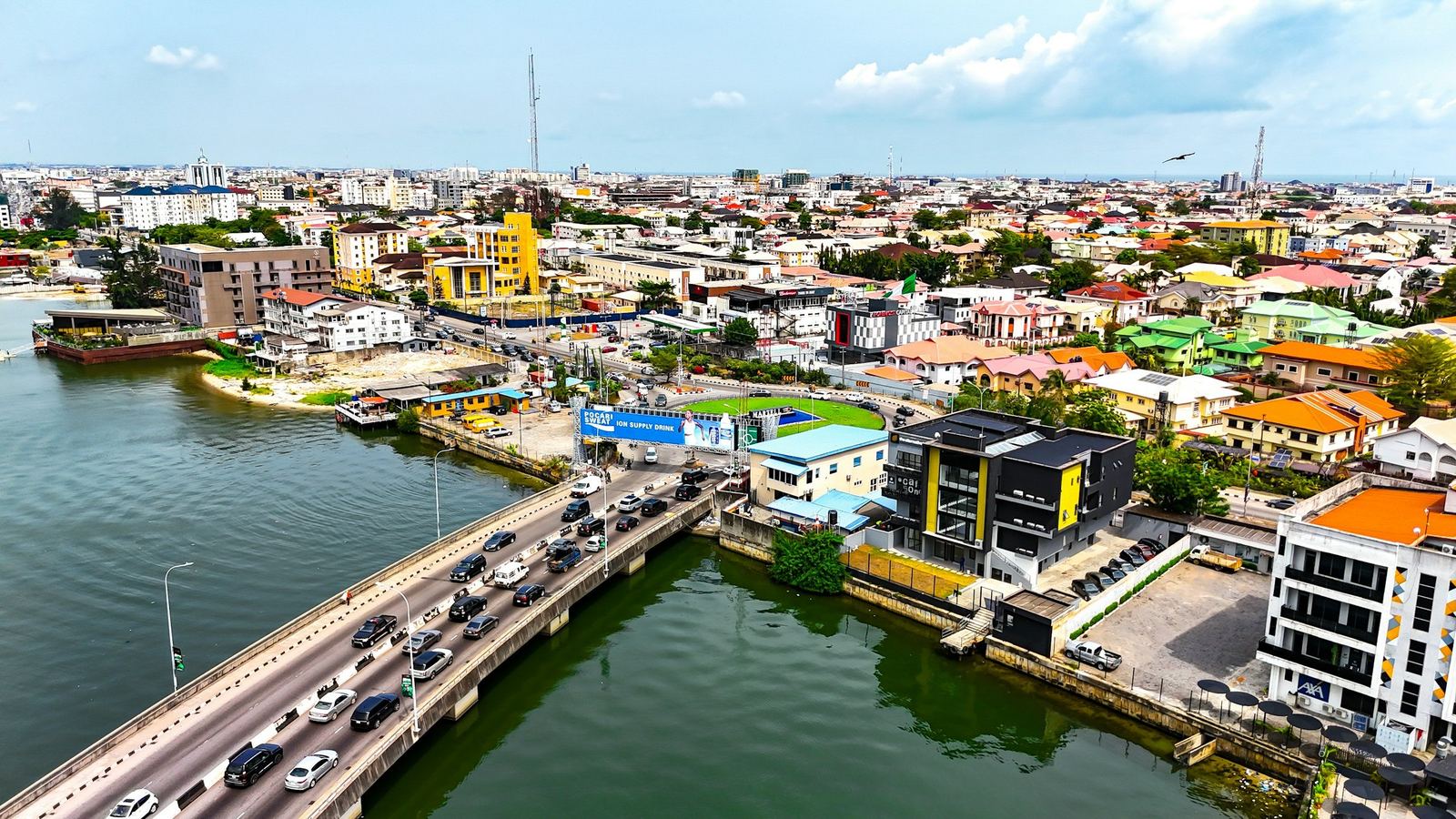 Real: Lagos from the air, a bridge over the lagoon and the city behind
